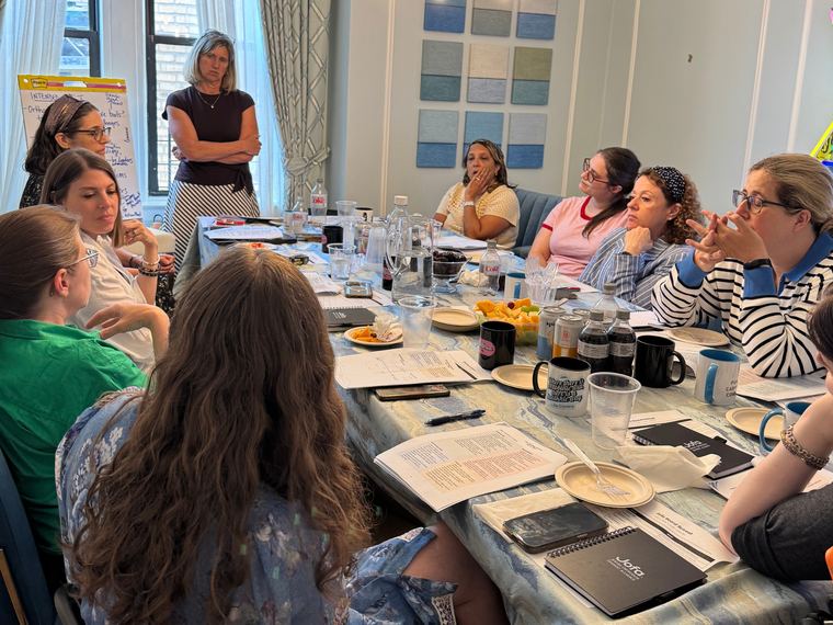 Participants seated around a long table at a Jofa community roundtable