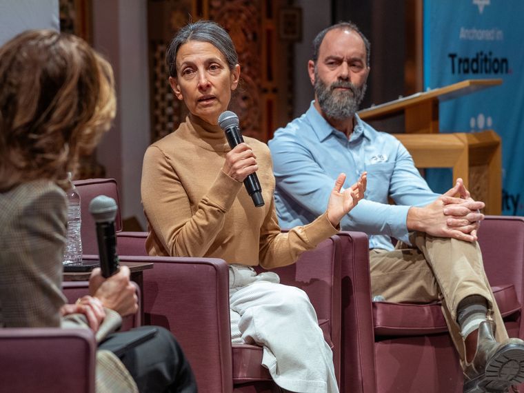 Rachel Goldberg-Polin speaking into a microphone beside Jon Polin during a Jofa fireside chat